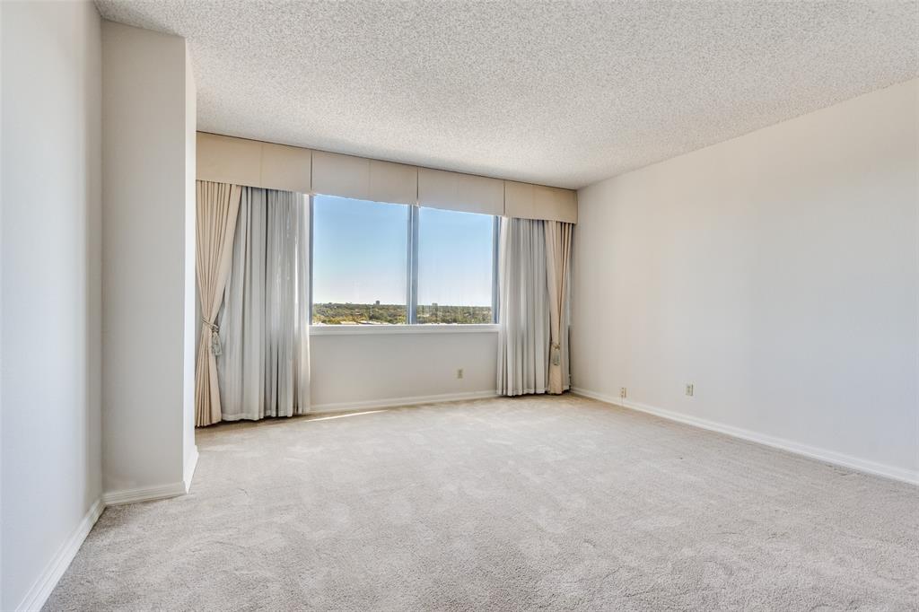 5200 Keller Springs Road, Unit 820 Dallas, TX 75248 - Photo 15 of 40 a view of an empty room with a kitchen