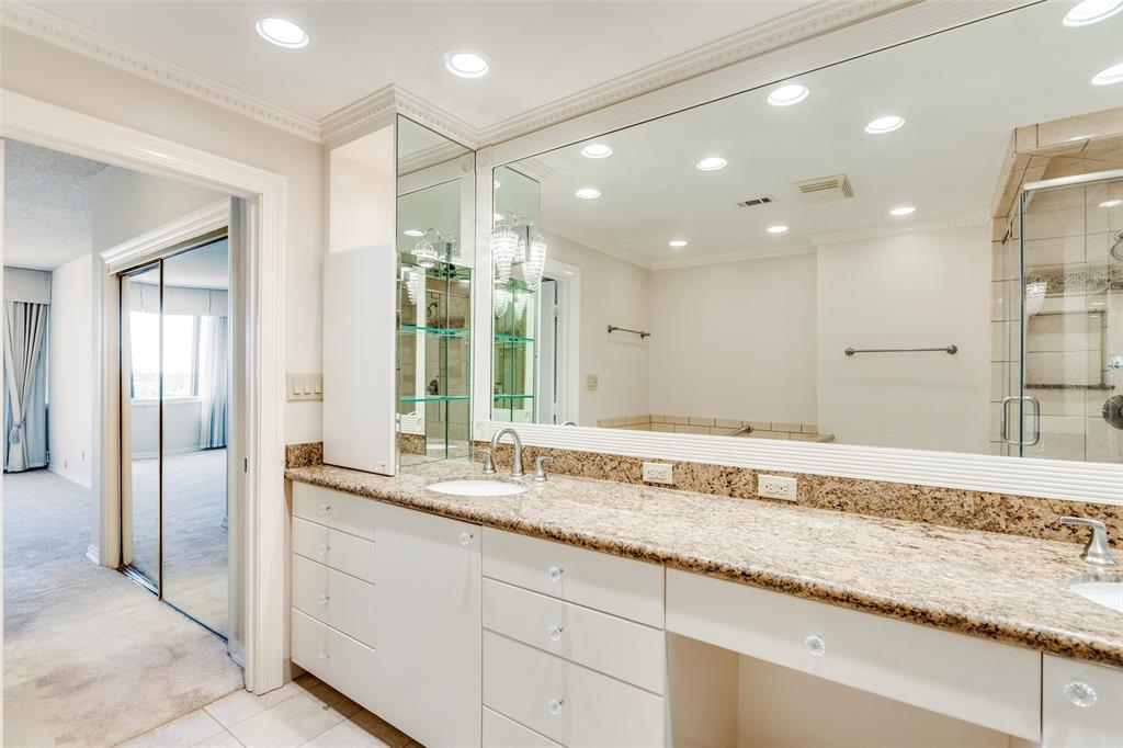 5200 Keller Springs Road, Unit 820 Dallas, TX 75248 - Photo 18 of 40 a bathroom with a granite countertop sink and a large mirror