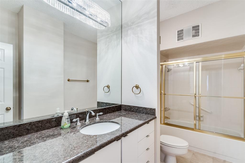 5200 Keller Springs Road, Unit 820 Dallas, TX 75248 - Photo 21 of 40 a bathroom with a granite countertop sink toilet mirror and shower