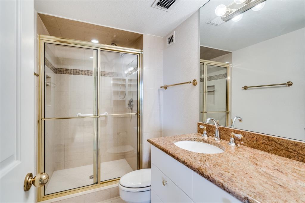 5200 Keller Springs Road, Unit 820 Dallas, TX 75248 - Photo 23 of 40 a bathroom with a granite countertop sink mirror and shower