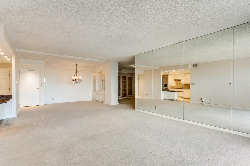 5200 Keller Springs Road, Unit 820 Dallas, TX 75248 - Photo 5 of 40 an empty room with fireplace and windows