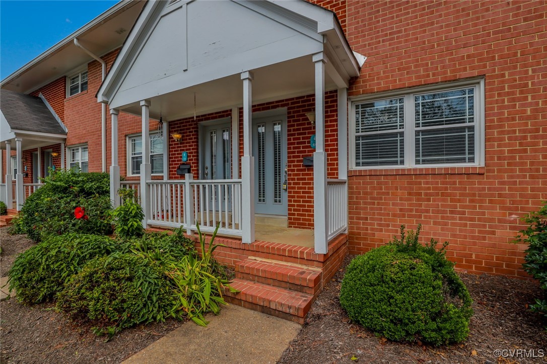 3109 North Parham Road, Unit 40 Henrico, VA 23294 - Photo 5 of 40 a view of a house with a small yard and flower plants