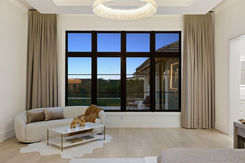 7117 Davenport Divide Road Austin, TX 78738 - Photo 11 of 40 Floor-to-ceiling windows flood this elegant sitting area with natural light and offer expansive outdoor views.