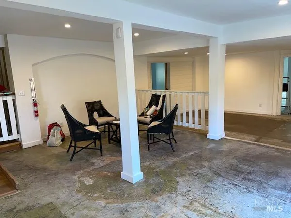 an empty room with wooden floor and window