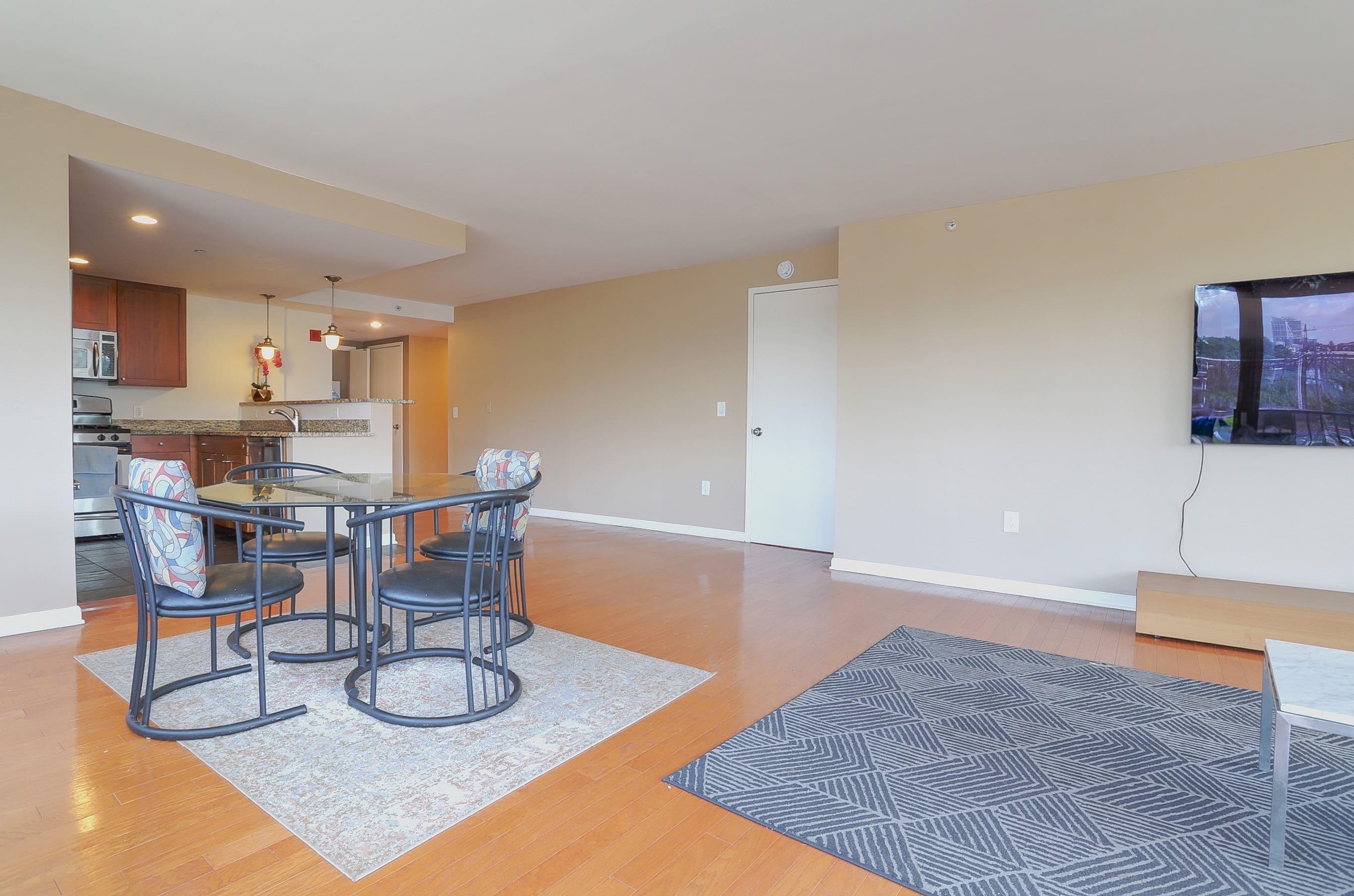 700 Grove Street, Unit 4F Jersey City, NJ 07310 - Photo 4 of 30 a dining room with wooden floor and kitchen view