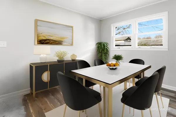 a view of a dining room with furniture and wooden floor
