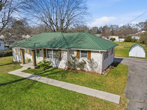 a front view of a house with a yard table and chairs