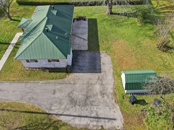 an aerial view of a house with a yard