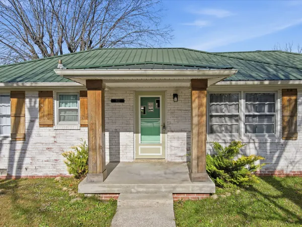 a front view of a house with a garden