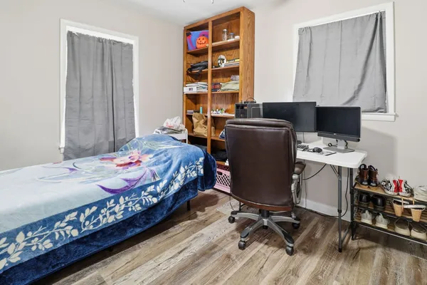 a bedroom with a bed and a desk in it