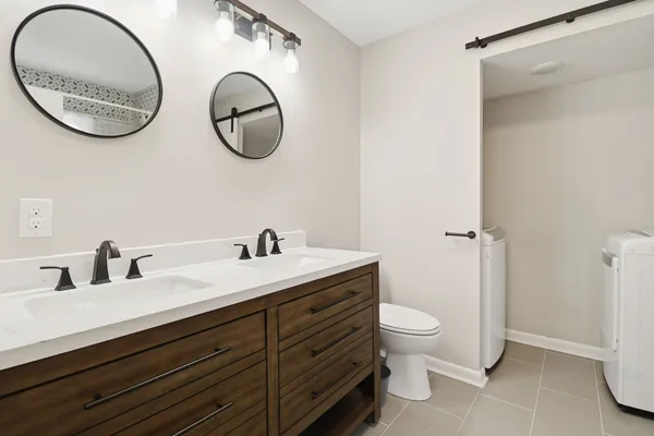 a bathroom with a toilet a sink and a mirror