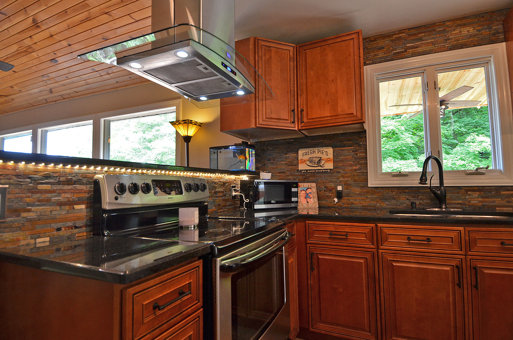 2580 East 1251st Road Ottawa, IL 61350 - Photo 6 of 29 a kitchen with stainless steel appliances granite countertop a sink a stove and a microwave