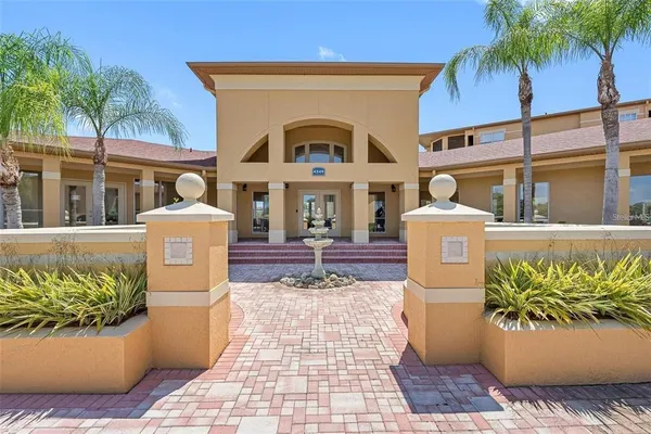 a front view of a house with fountain