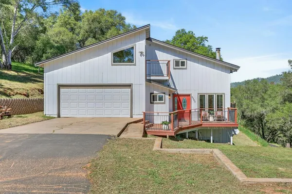 a front view of house with yard outdoor seating and barbeque oven