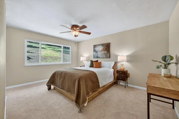a bedroom with a bed and a window