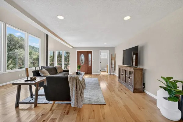 a living room with a fireplace and a floor to ceiling window
