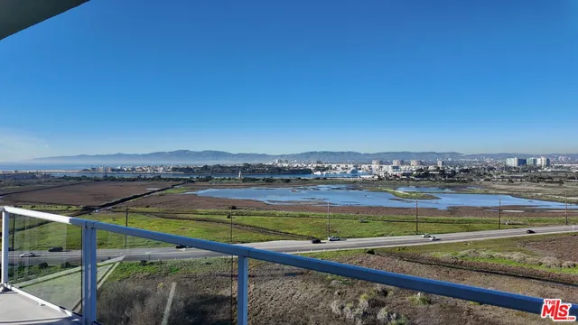a view of kitchen with kitchen island and a large window