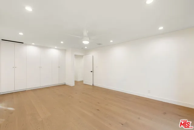 a view of stairs and hall with wooden floor