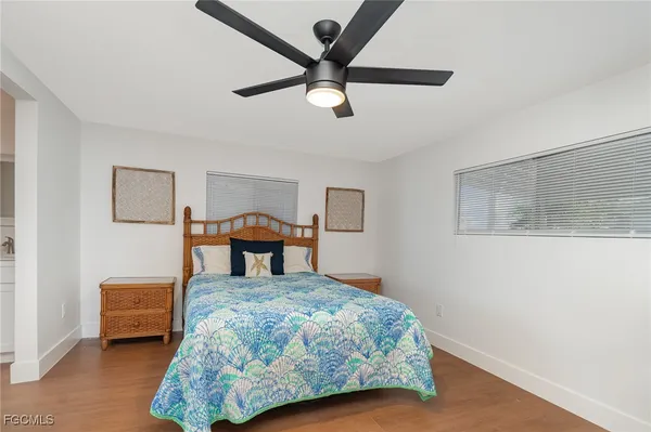 a bedroom with furniture and a ceiling fan