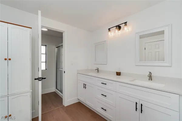 a bathroom with a double vanity sink mirror and double