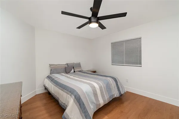 a bedroom with a bed and painting on the wall