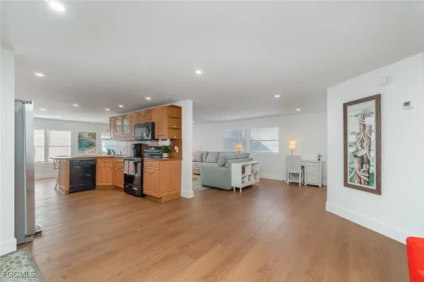 a living room with furniture and kitchen view