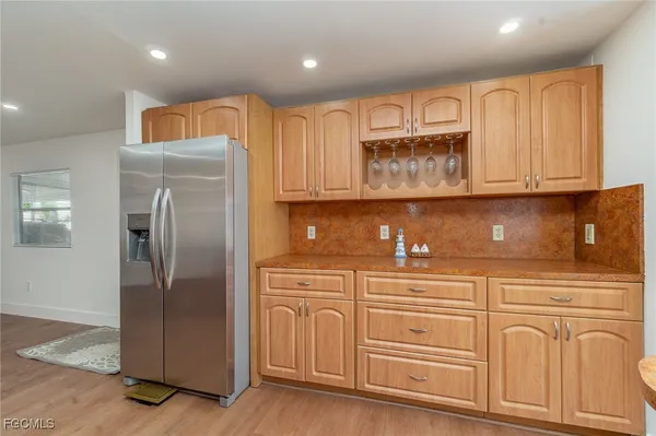 a kitchen with stainless steel appliances granite countertop a refrigerator and a stove top oven