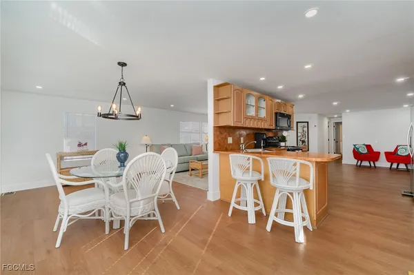a dining room with furniture and wooden floor