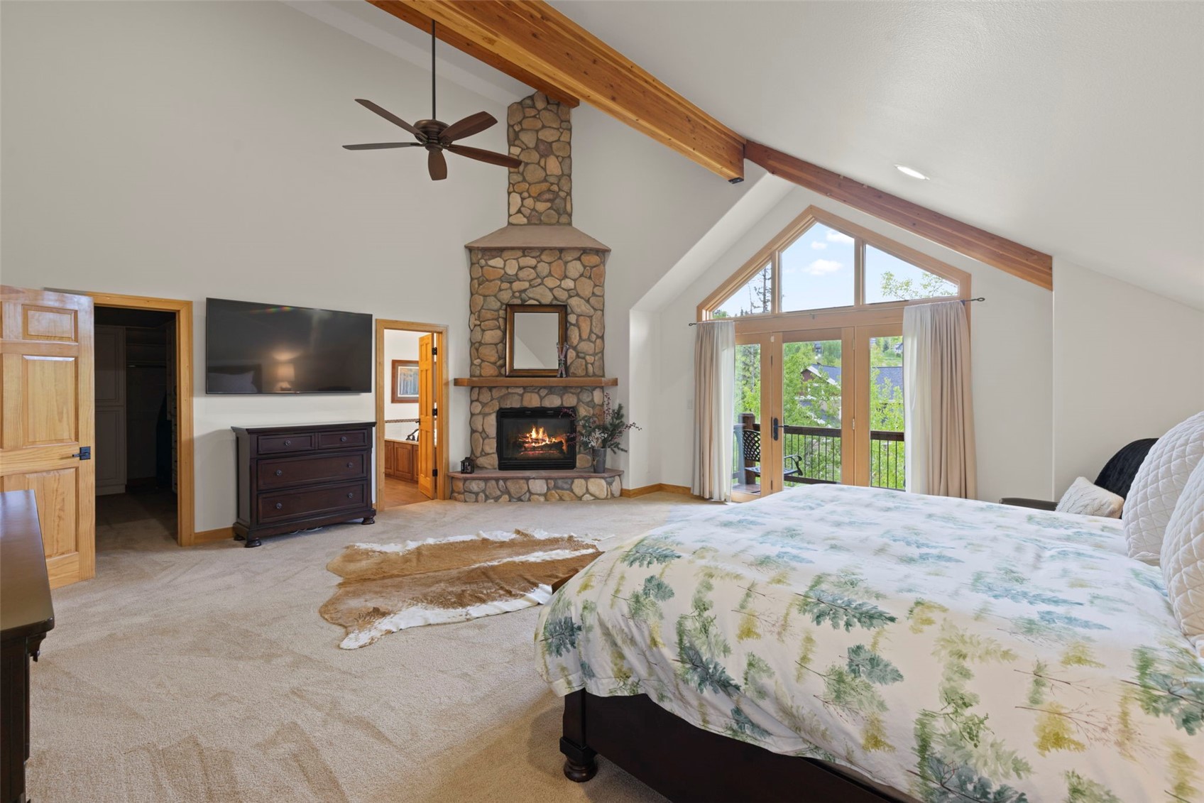 736 Wild Rose Road Silverthorne, CO 80498 - Photo 25 of 49 Carpeted bedroom with access to exterior, beam ceiling, a fireplace, and high vaulted ceiling