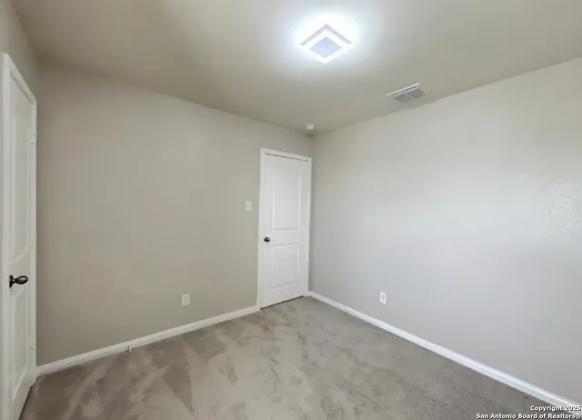 a view of an empty room and window