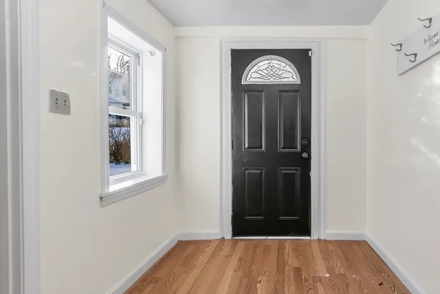 a kitchen with a dining table chairs and white cabinets