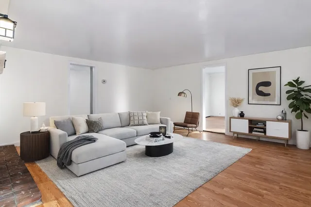wooden floor fireplace and windows in an empty room