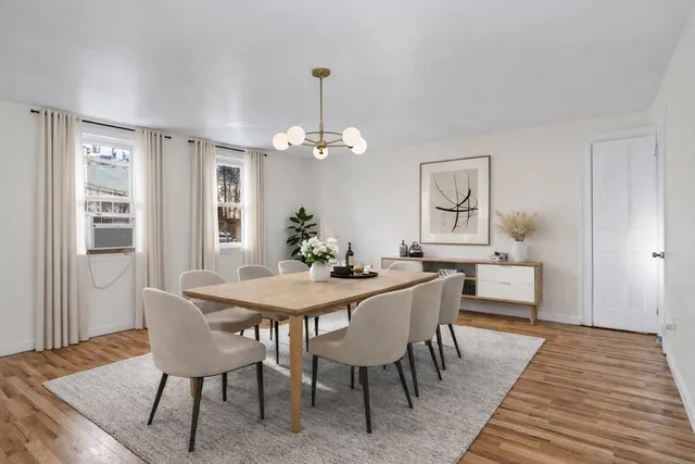 a view of a livingroom with wooden floor and a fireplace