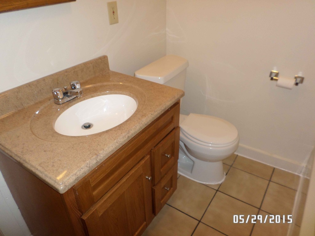 265-267 Water Street Springfield, MA 01151 - Photo 17 of 23 a bathroom with a sink a toilet and a mirror