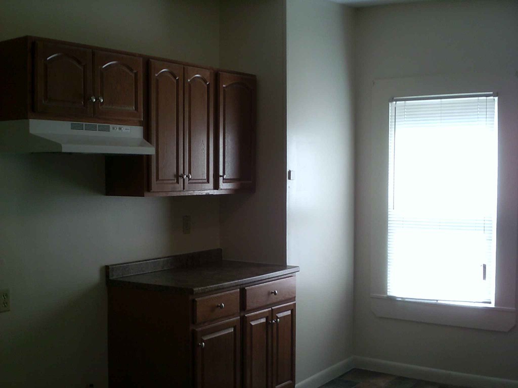 265-267 Water Street Springfield, MA 01151 - Photo 5 of 23 a kitchen with wooden cabinets and a stove