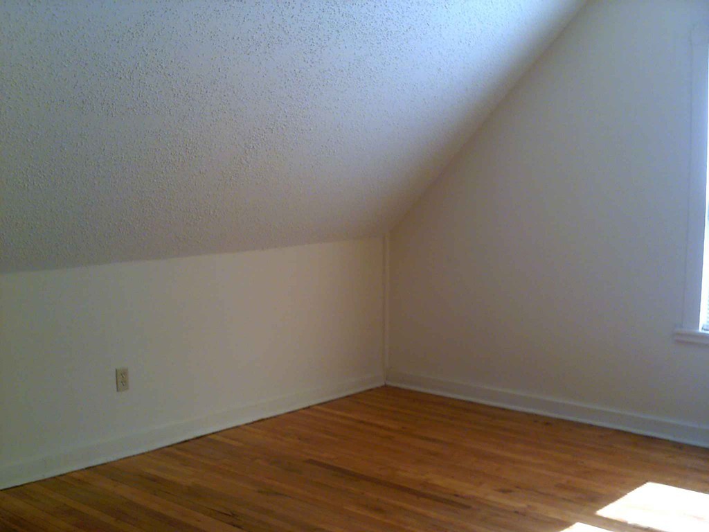 265-267 Water Street Springfield, MA 01151 - Photo 6 of 23 a view of an empty room with wooden floor and fan