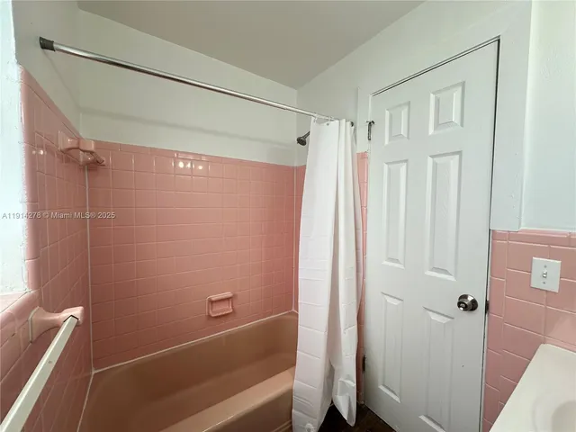 a bathroom with a shower and a tub