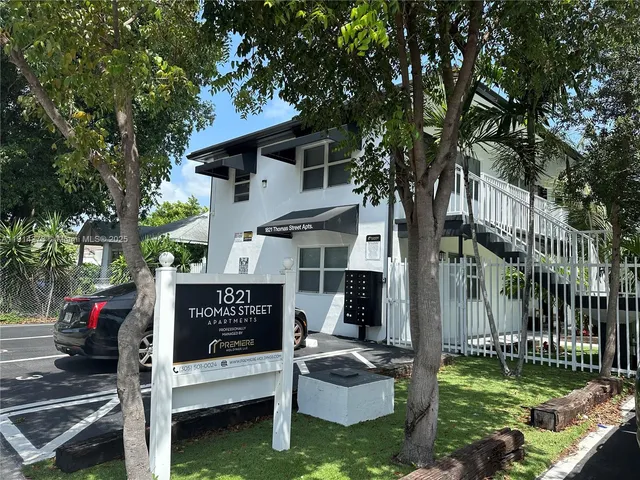 a view of a house with a yard balcony and furniture