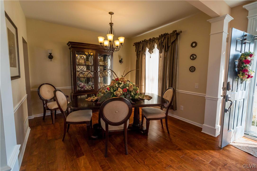 8785 Pathfinder Road Breinigsville, PA 18031 - Photo 4 of 28 Formal dining room with hardwood floors and chair