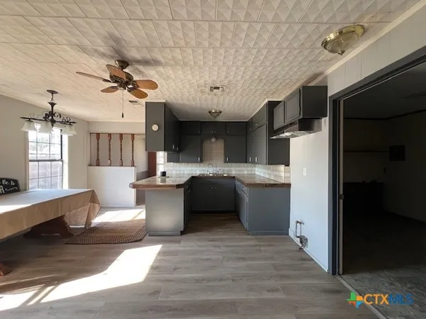a kitchen with a refrigerator and a sink