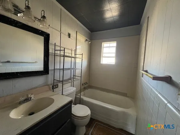 a bathroom with a sink toilet bathtub and mirror