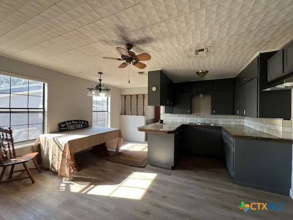a large kitchen with stainless steel appliances granite countertop a stove and a refrigerator