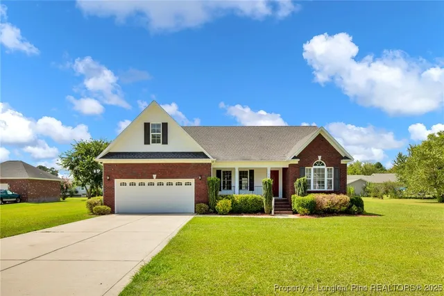 a front view of a house with a yard and garage