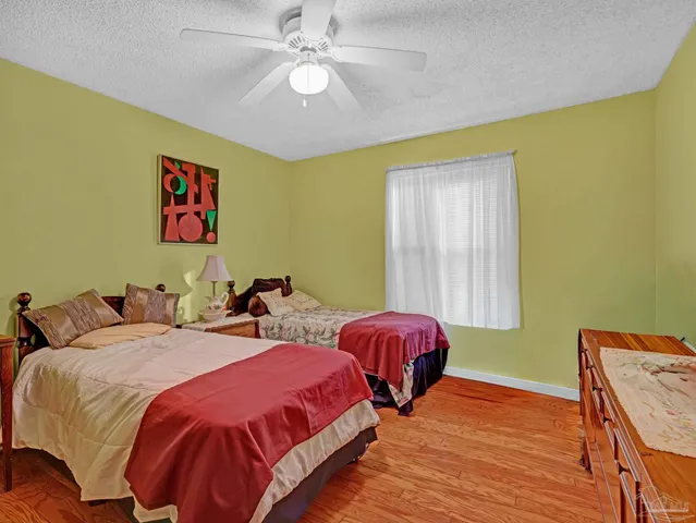 a bedroom with 2 bed and a chandelier
