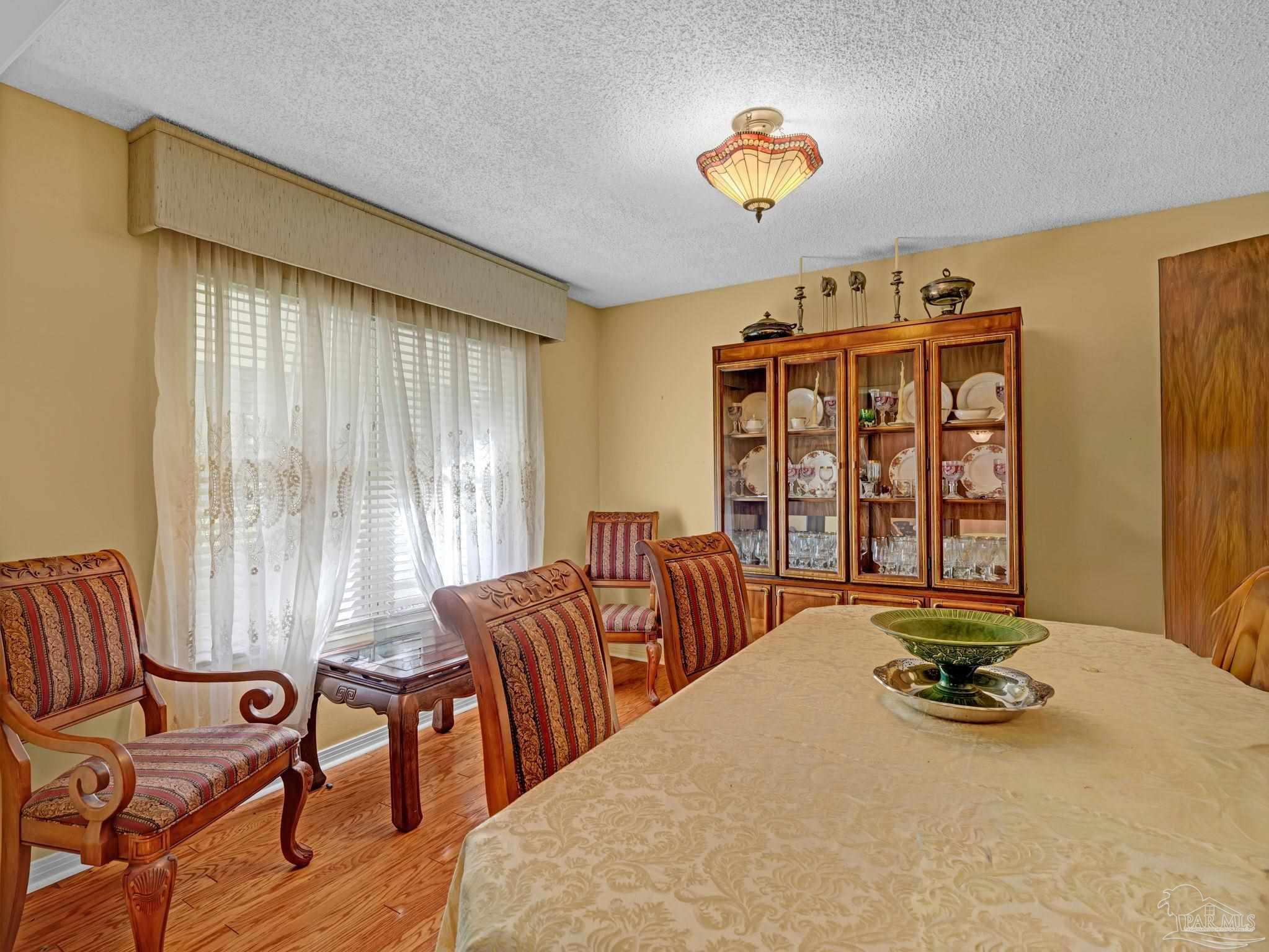 4112 Croydon Road Pensacola, FL 32514 - Photo 2 of 25 a bedroom with furniture and a large window