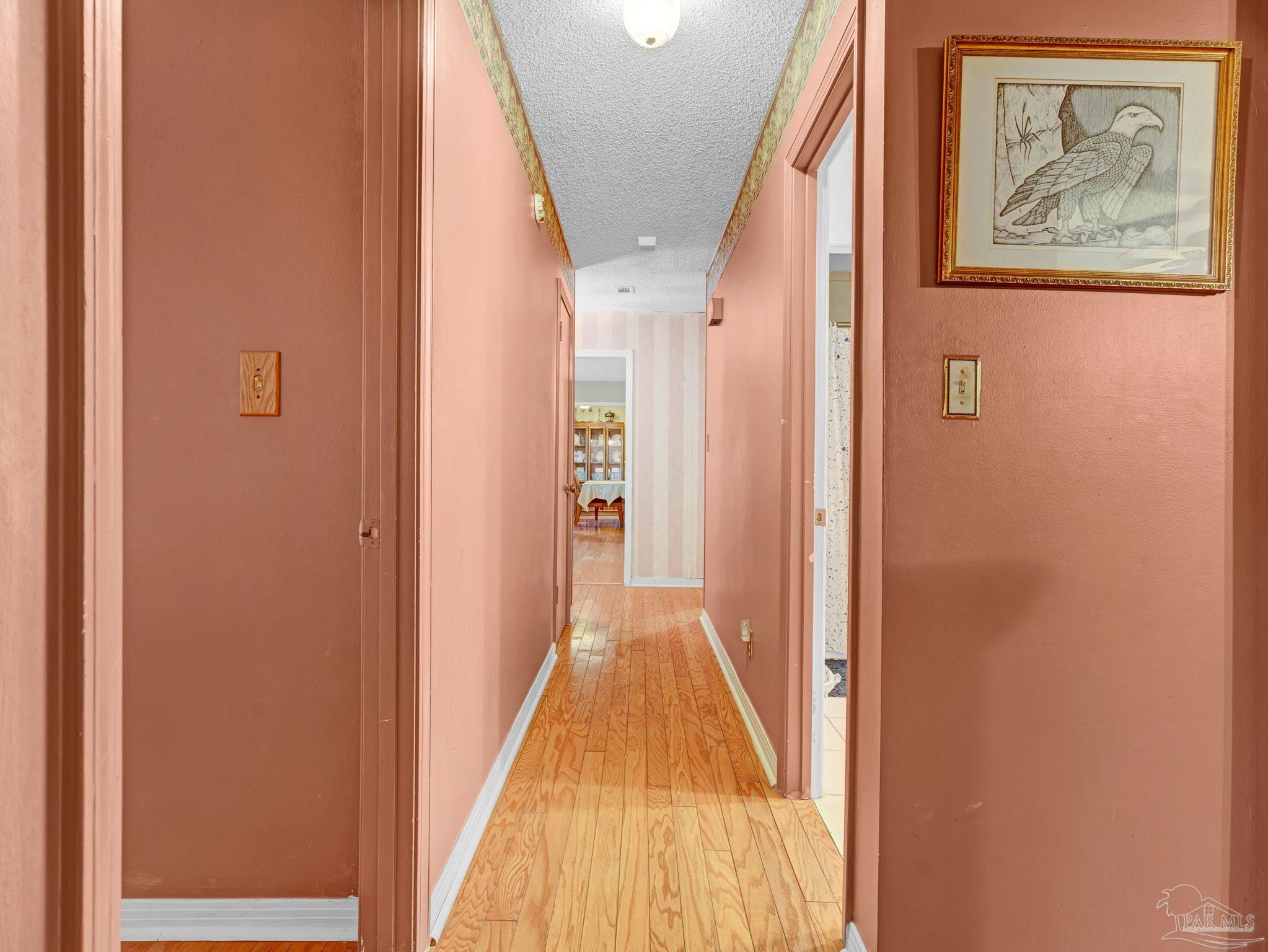 4112 Croydon Road Pensacola, FL 32514 - Photo 24 of 25 a view of a hallway with wooden floor and stairs