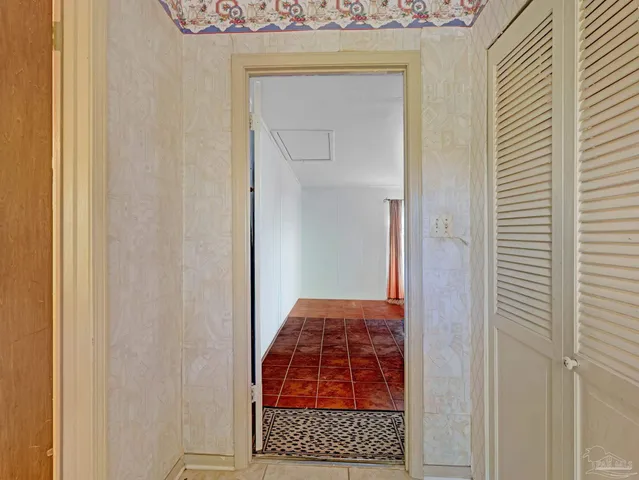 a bedroom with a bed and a mirror