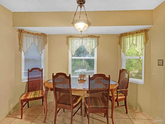 a dining room with furniture and window