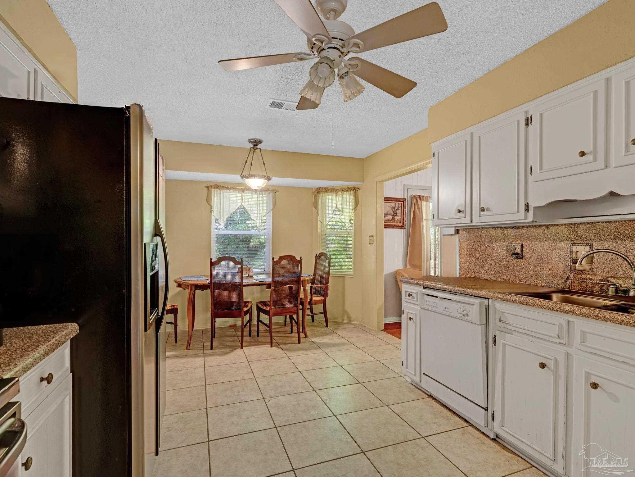 4112 Croydon Road Pensacola, FL 32514 - Photo 6 of 25 a kitchen with granite countertop cabinets and stainless steel appliances