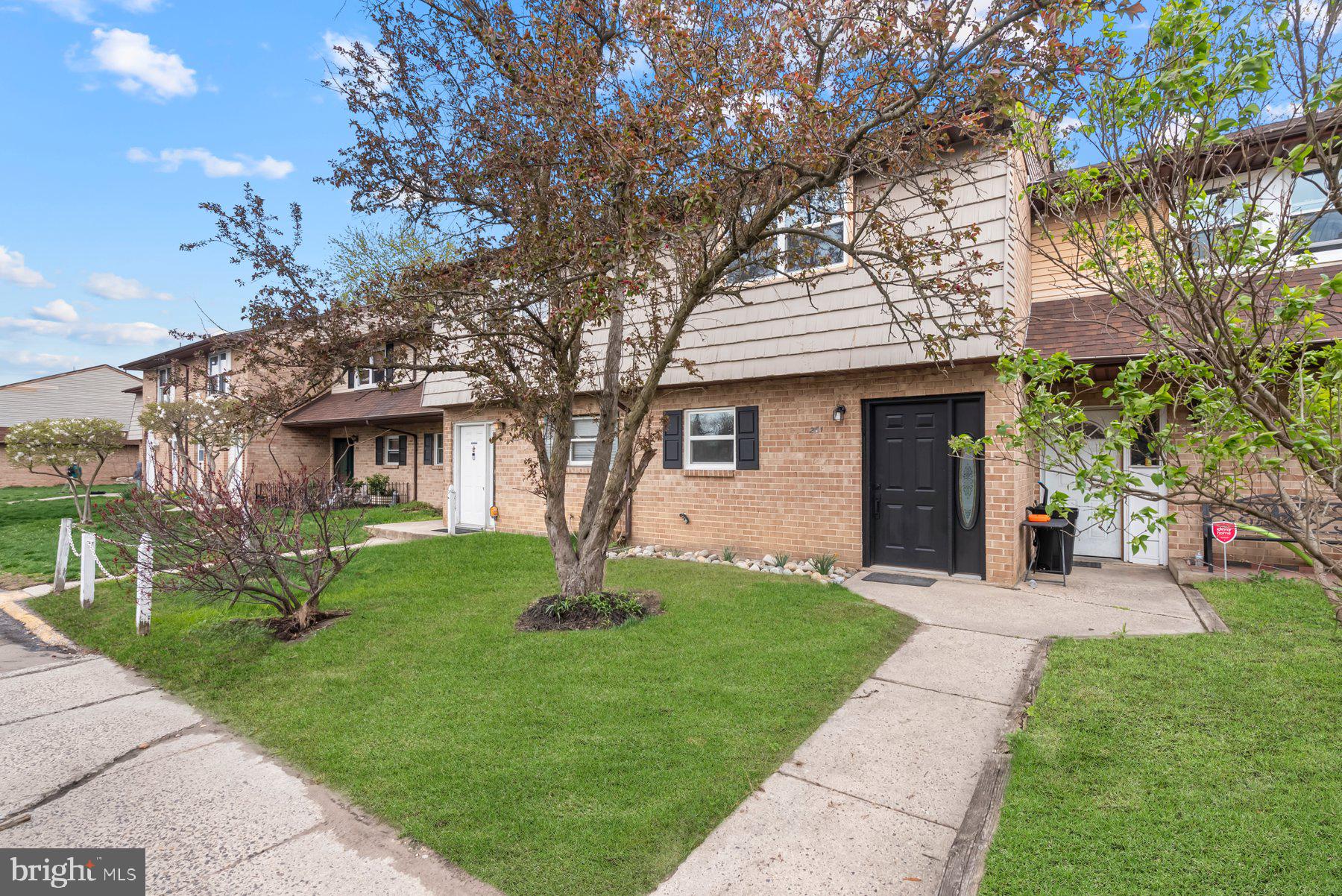 a view of a house with a yard and tree s